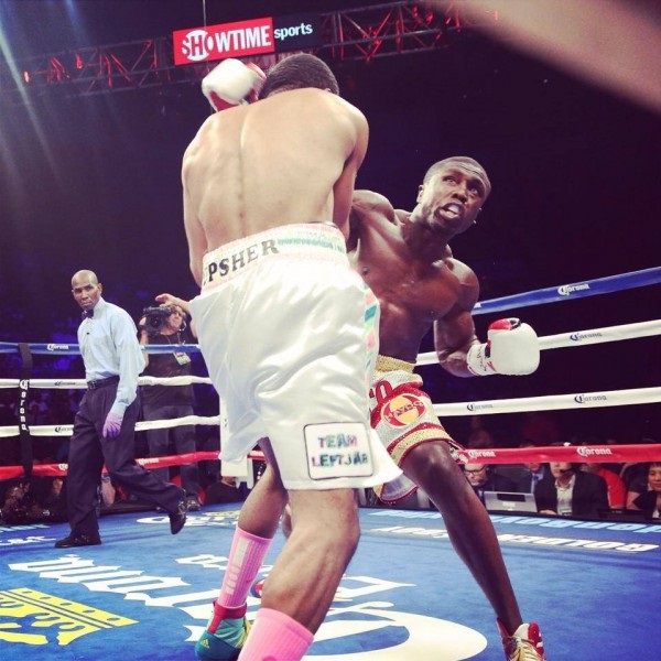 Kamal Hasan referees a welterweight bout between Andre Berto (right) and Steve Upsher.