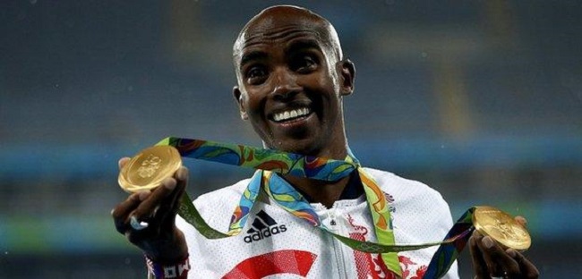 Mo Farah of Great Britain shows his two gold medals from Rio.