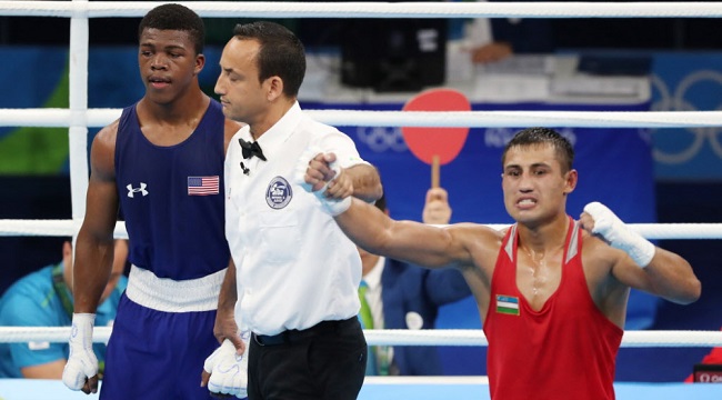 Fazliddin Gaibnazarov of Uzbekistan (right) defeated Gary Russell of the U.S.